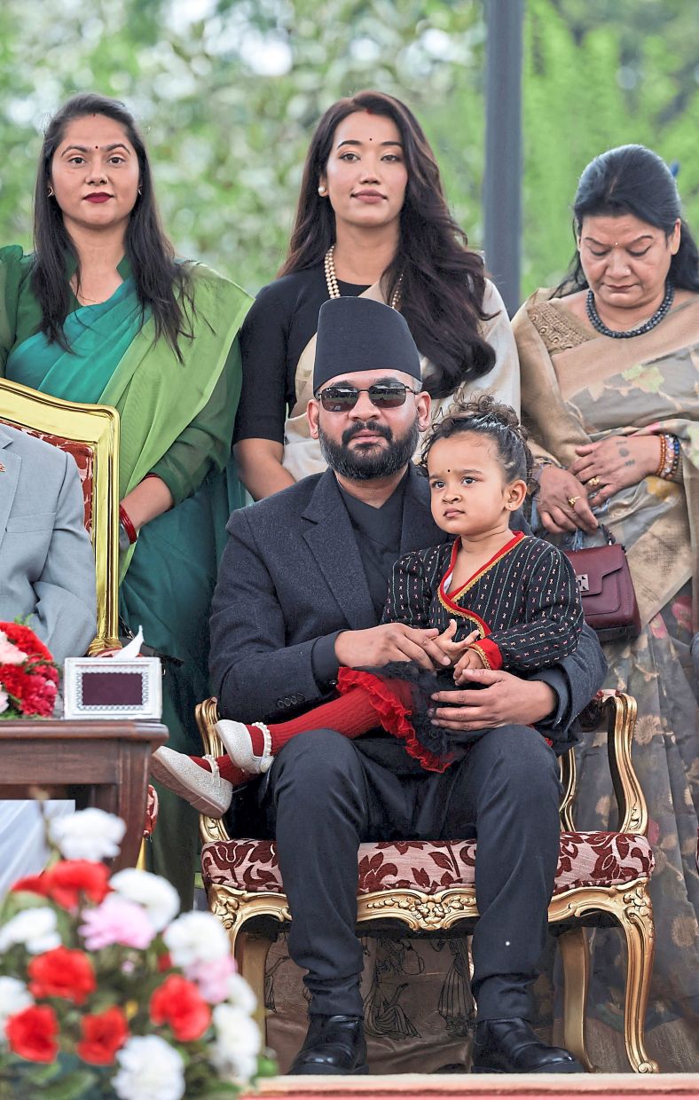 New era begins: Shah holding his daughter Niloufer as First Lady Sabina Kafle stands behind him during his oath-taking ceremony at Shital Niwas, the presidential residence in Kathmandu. — Reuters
