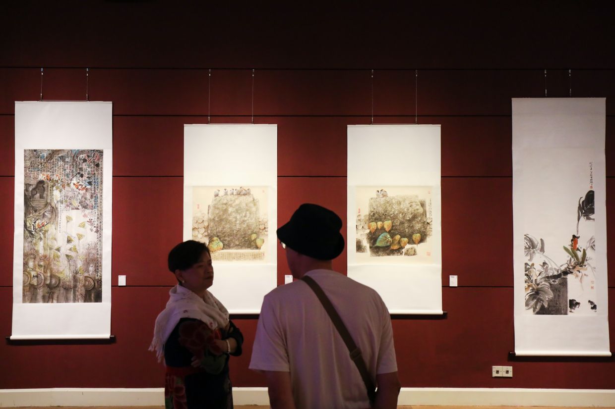 Two ink-on-rice-paper works (centre) by late artist Lai Tiew Seong, seen at the start of the exhibition. Photo: The Star/Leong Wai Yee