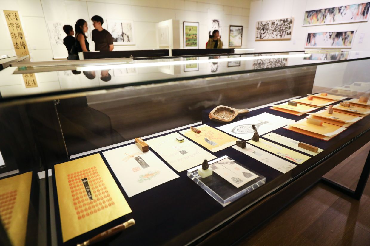 The third floor of the exhibition offers a glimpse into the world of seal engraving, spanning both traditional and contemporary styles. Photo: The Star/Leong Wai Yee