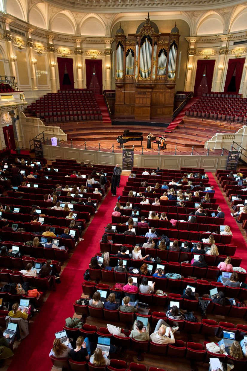 Students use their laptops while studying with music at Concertgebouw in Amsterdam, Netherlands, on March 5, 2026. (AP Photo/Peter Dejong)