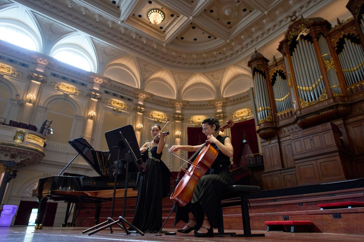 Violinist Hyunjin Cho, left, and cellist Efstratia Chaloulakou perform for students studying with music at Concertgebouw in Amsterdam, Netherlands, on March 5, 2026. 