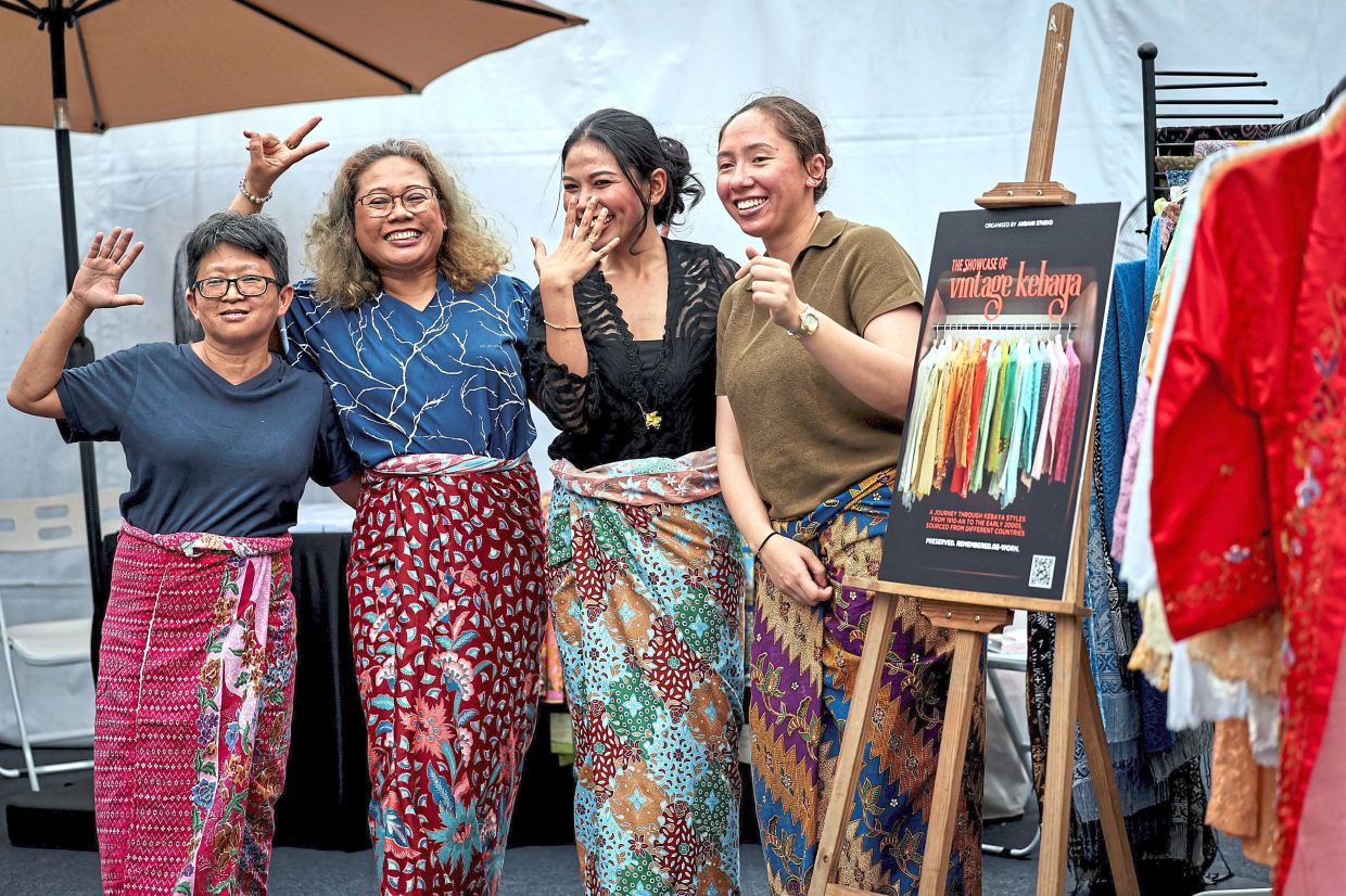 Zulaikha (second from right) and participants posing in their styled batik sarong. — Photos: Bernama