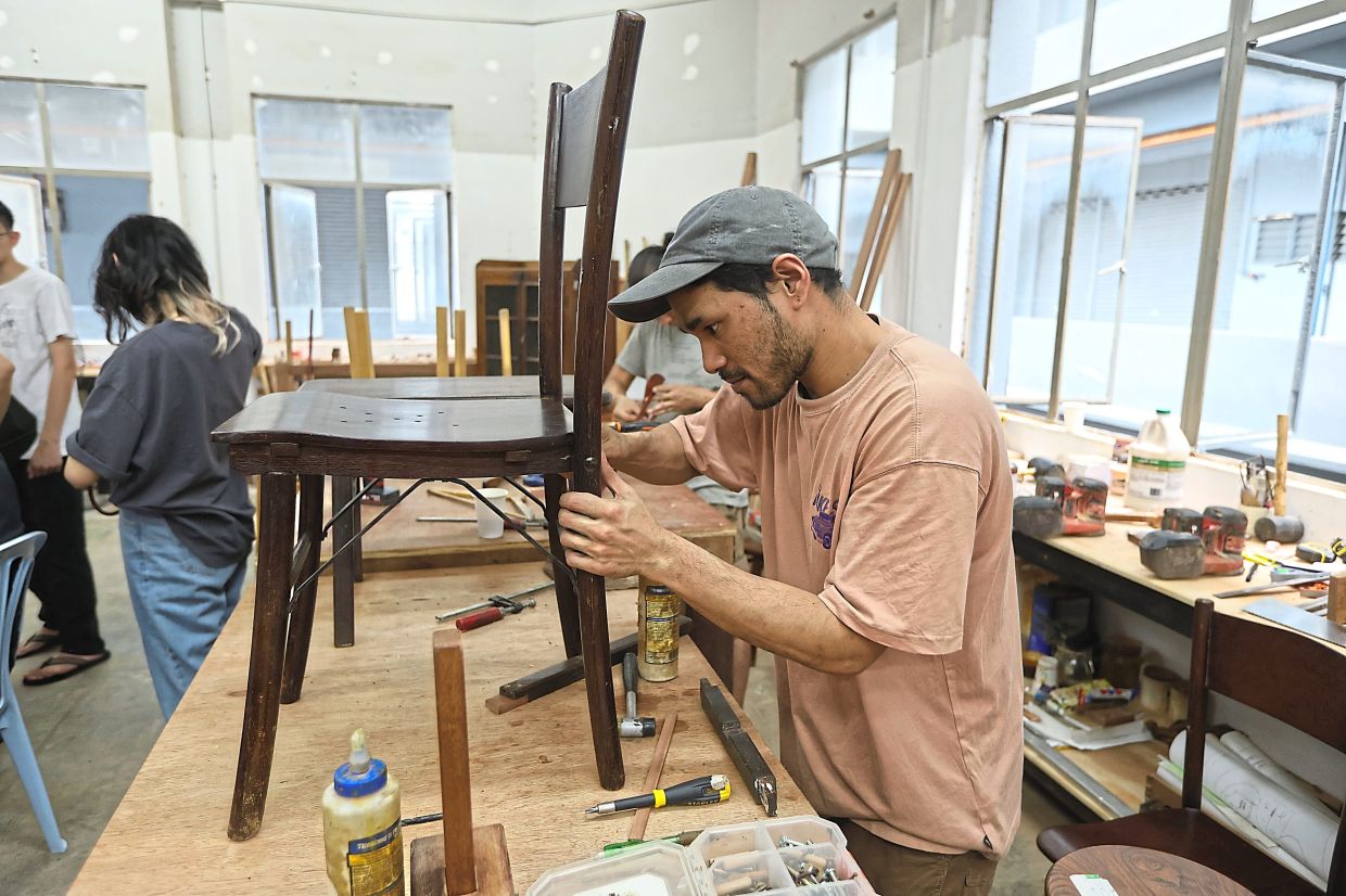 Dev fixing the legs on a broken chair.