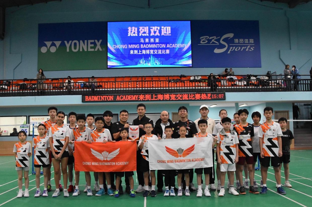 Good memories: Chan Chong Ming' academy players posing for a photo after completing training session with players from Cai Yun's club. 