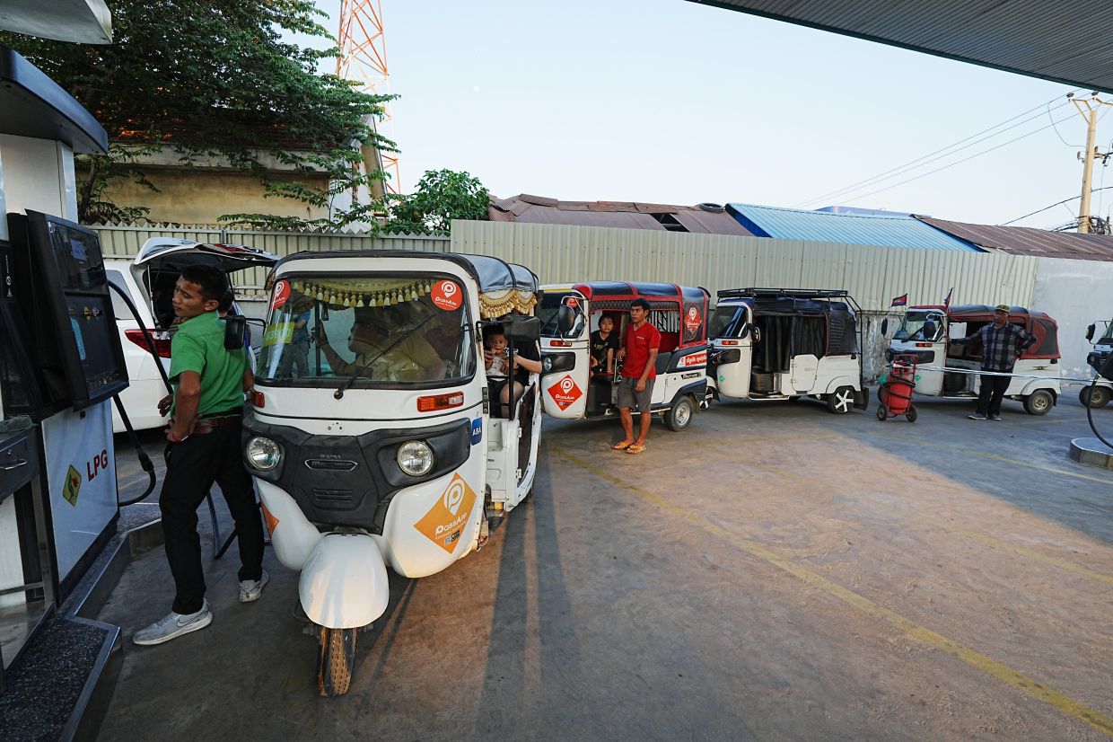 Tuk-tuk drivers line up to fill up with gas at a gas station in Phnom Penh, Cambodia, on Monday, March 30, 2026. -- AP Photo/Heng Sinith