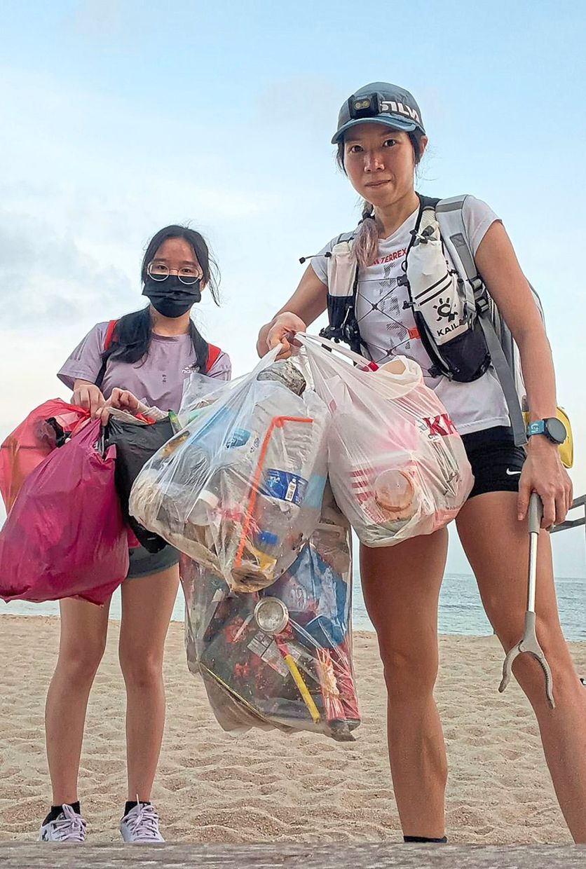 Khaw (right) and a friend showing the rubbish they collected on the beach in Batu Ferringhi, Penang. — Courtesy photos 