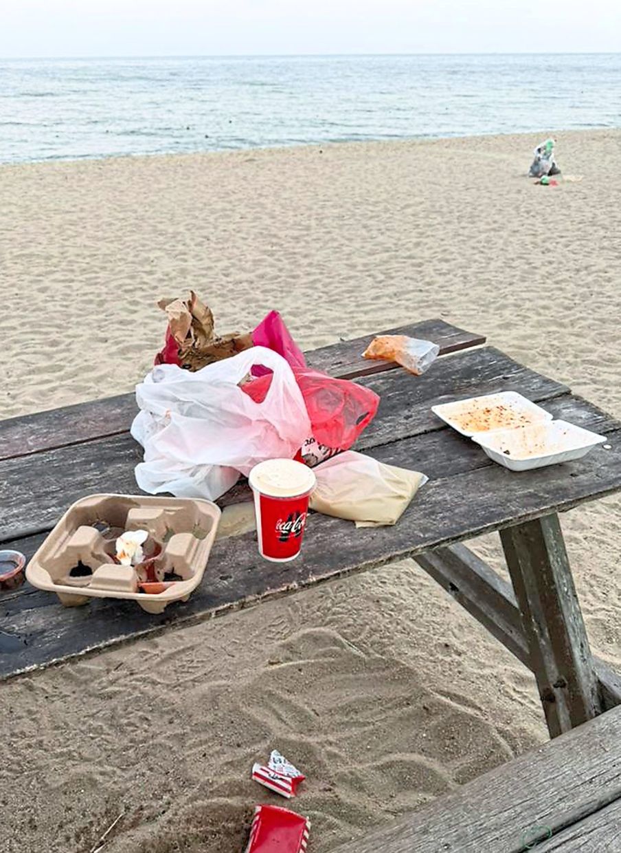 A picnic table with food packaging left behind (top) and remnants of firecrackers (above) marring the beauty and chill vibes of the beach. 