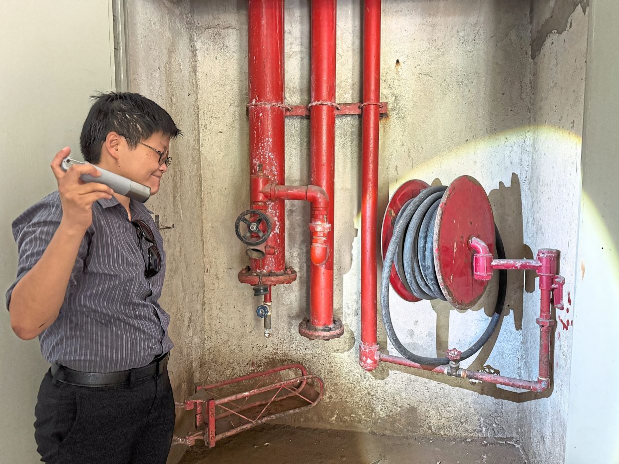 Lai checking that the Bukit OUG’s fire hose reels are in working order.