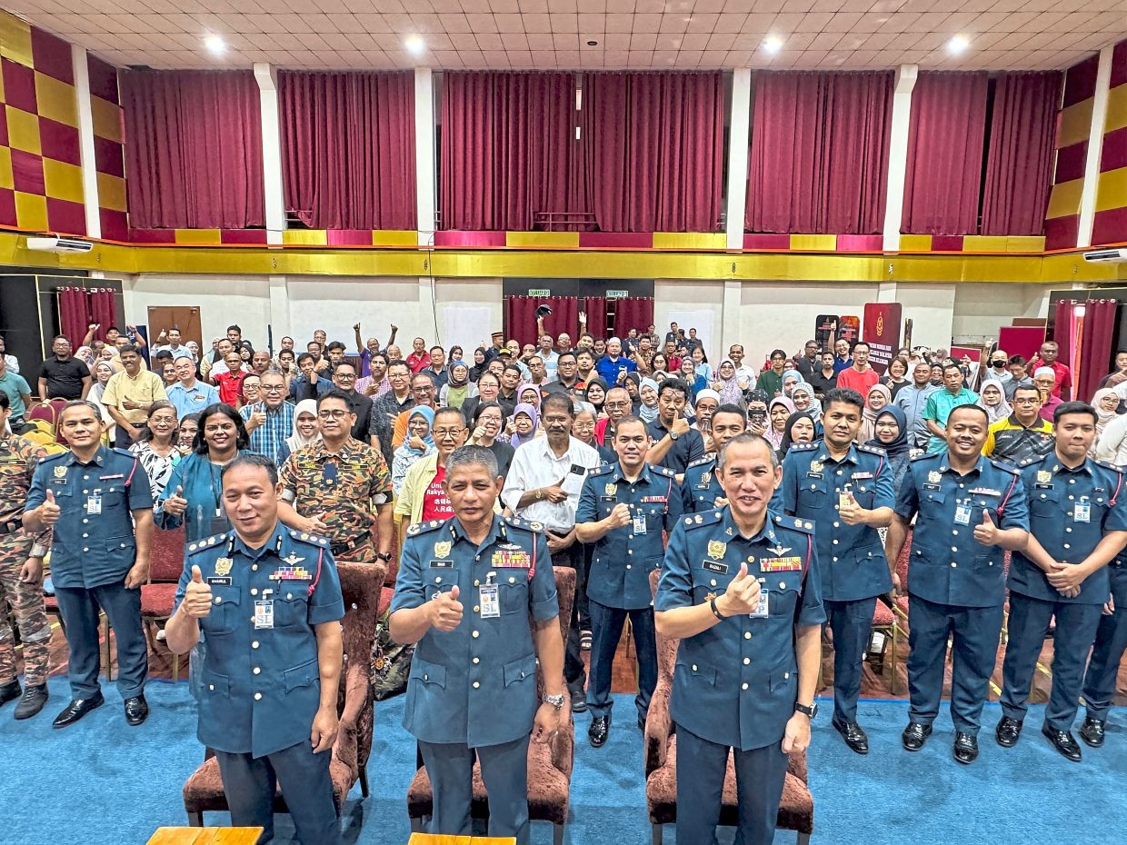 Wan Md Razali (middle) and Razali (right) with their colleagues after speaking to 200 representatives of joint management bodies at a town hall on the importance of fire safety at high-rise residences. The meeting was held at the Selangor Fire and Rescue headquarters in Bukit Jelutong, Shah Alam.