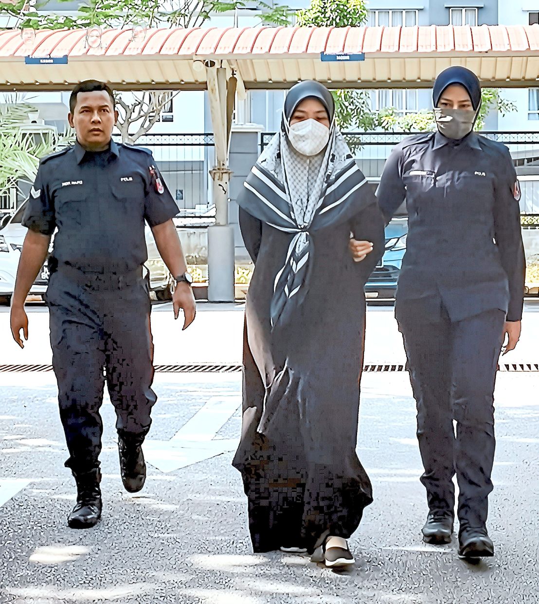 Day in court: The accused being taken away after the sentencing for the offence.