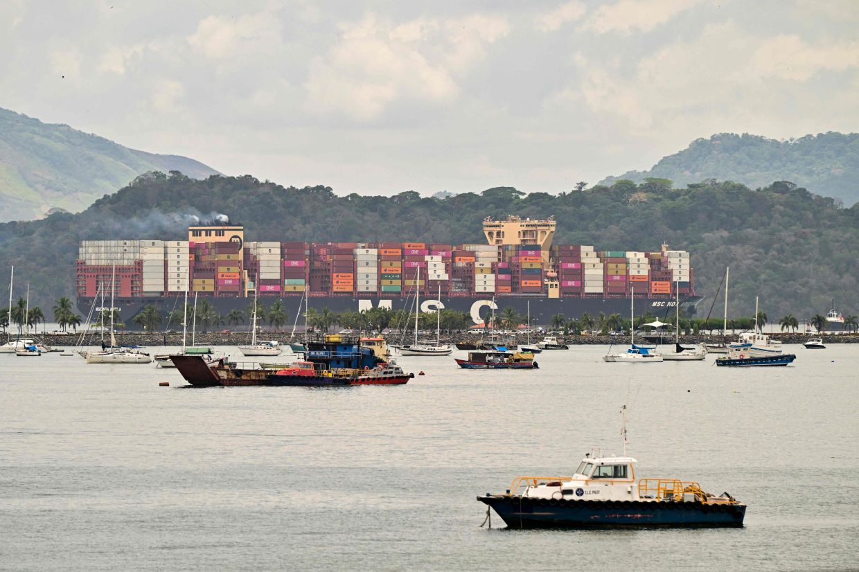 The MSC container ship, sailing under the flag of Singapore, enters the Panama Canal from the Pacific side in Panama City on March 29, 2026. (Photo by MARTIN BERNETTI / AFP)