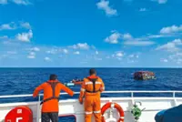 Rescuers find 21 people drifting on raft after boat sinks