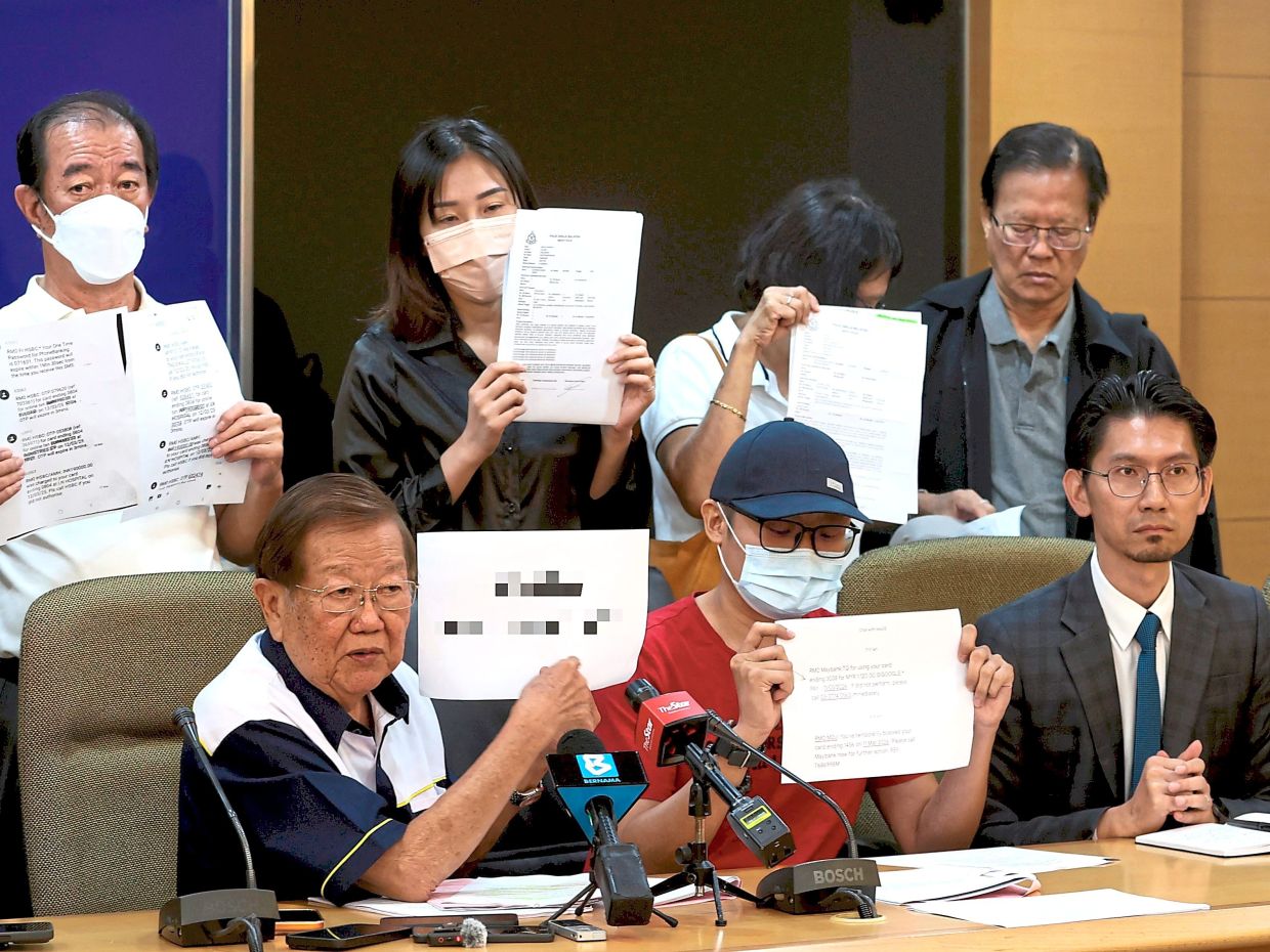 Quick action: Scam victims at the press conference with Chong. Most of the victims made prompt reports but were held liable by the banks. — CHAN TAK KONG/The Star