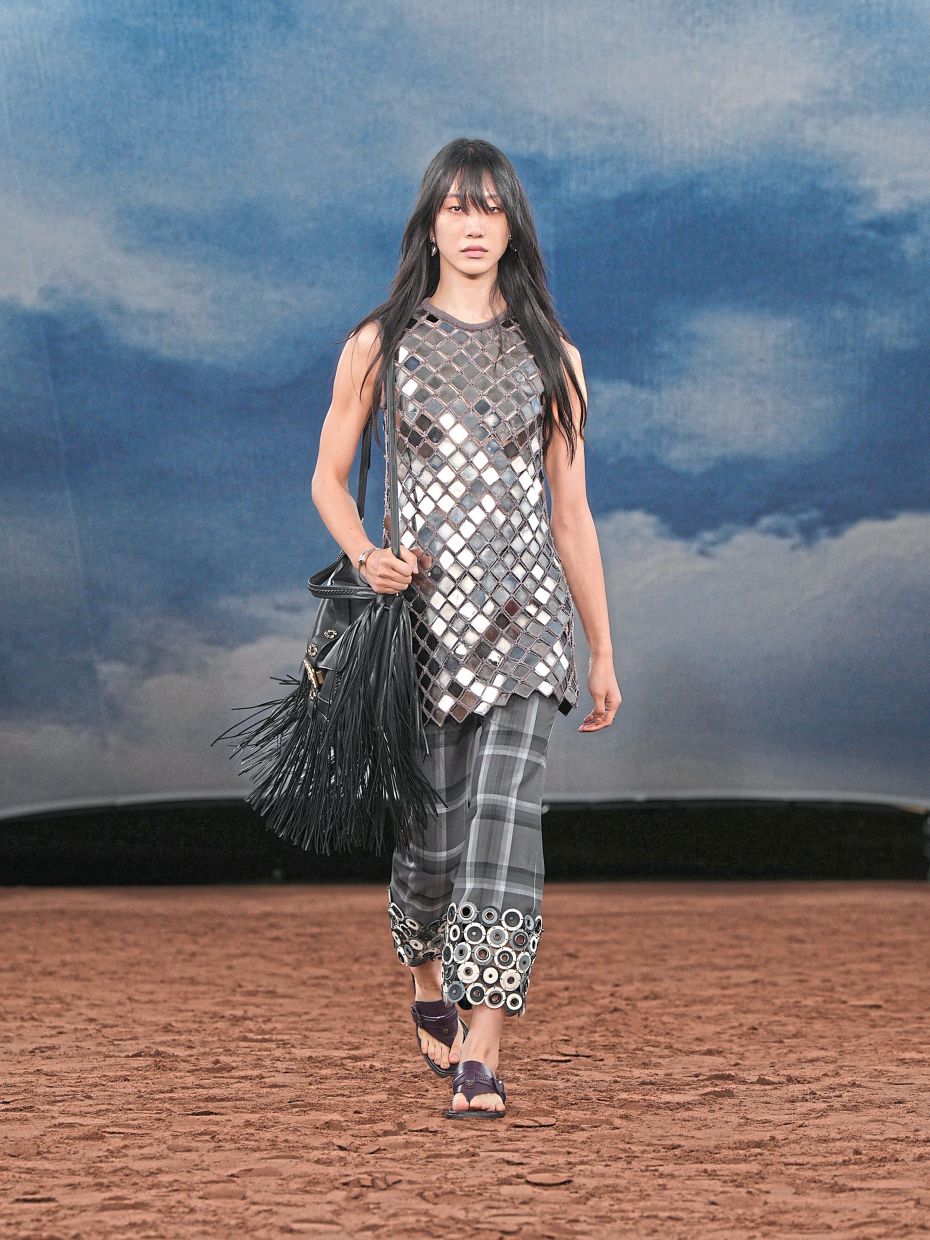 A fringed bag, circle-hemmed checked trousers, and a mirrored top are complemented by chappal-inspired sandals. Photo: Burberry
