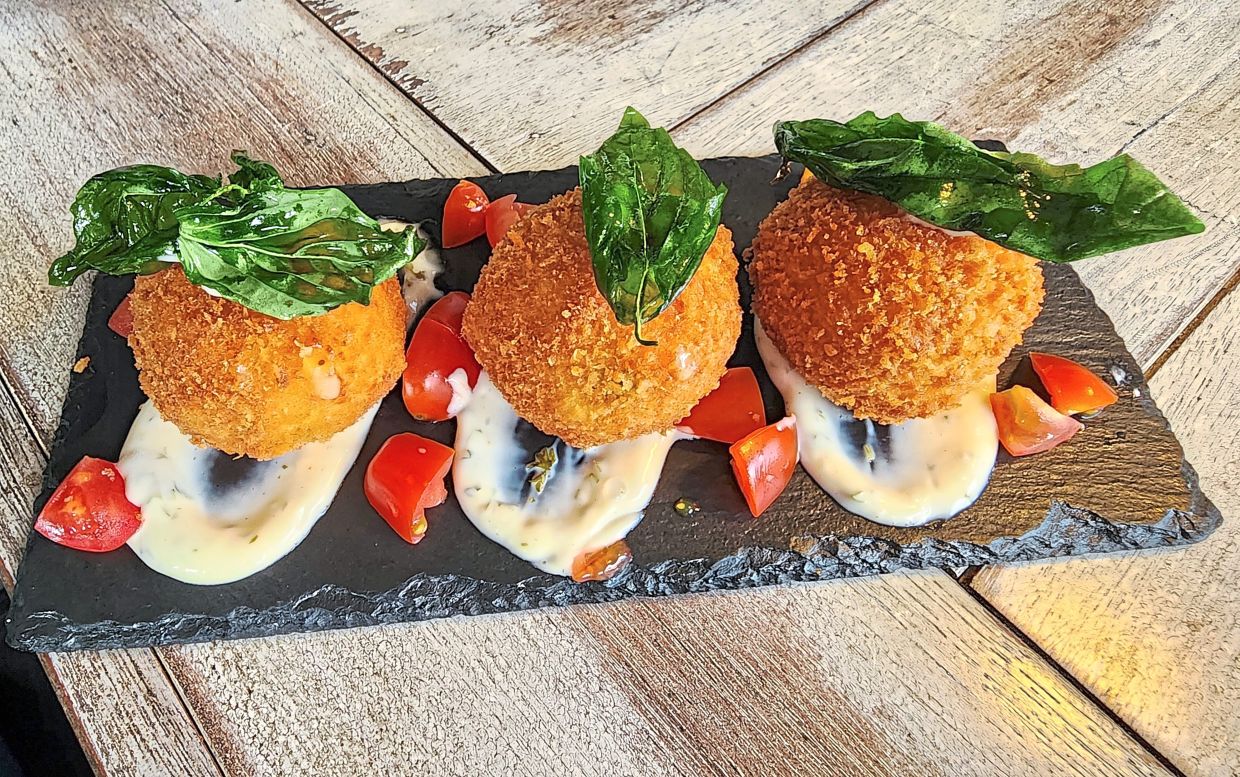 Crisp on the outside and indulgent on the inside, the arancini rice balls are addictively good. — ABIRAMI DURAI/The Star