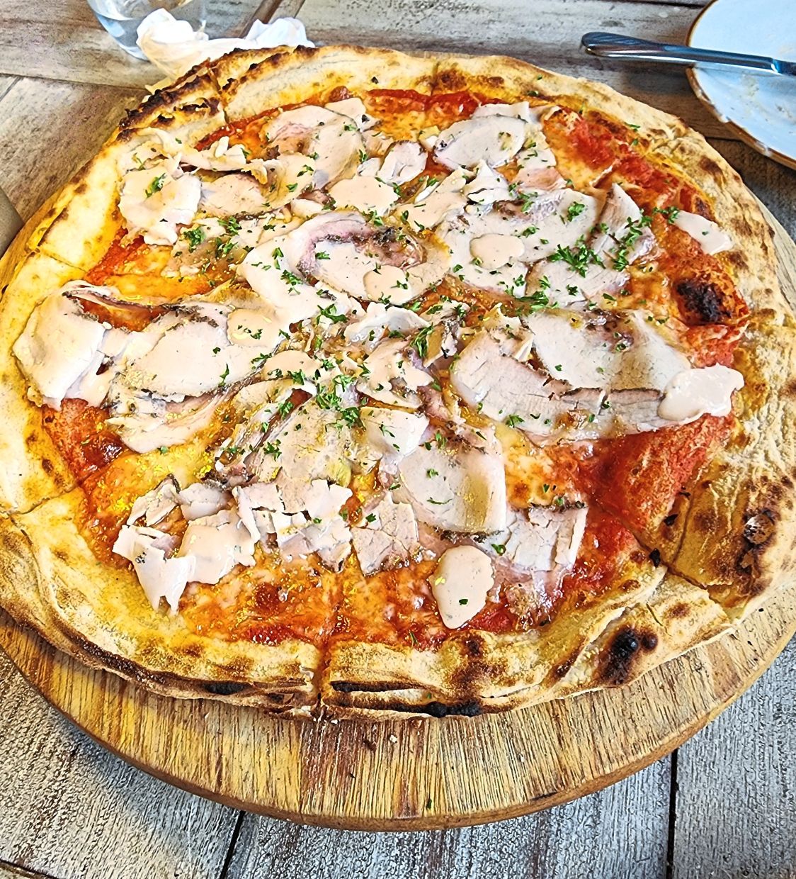 The pizza is chewy with a crispy edge and a rich porcine topping. — ABIRAMI DURAI/The Star