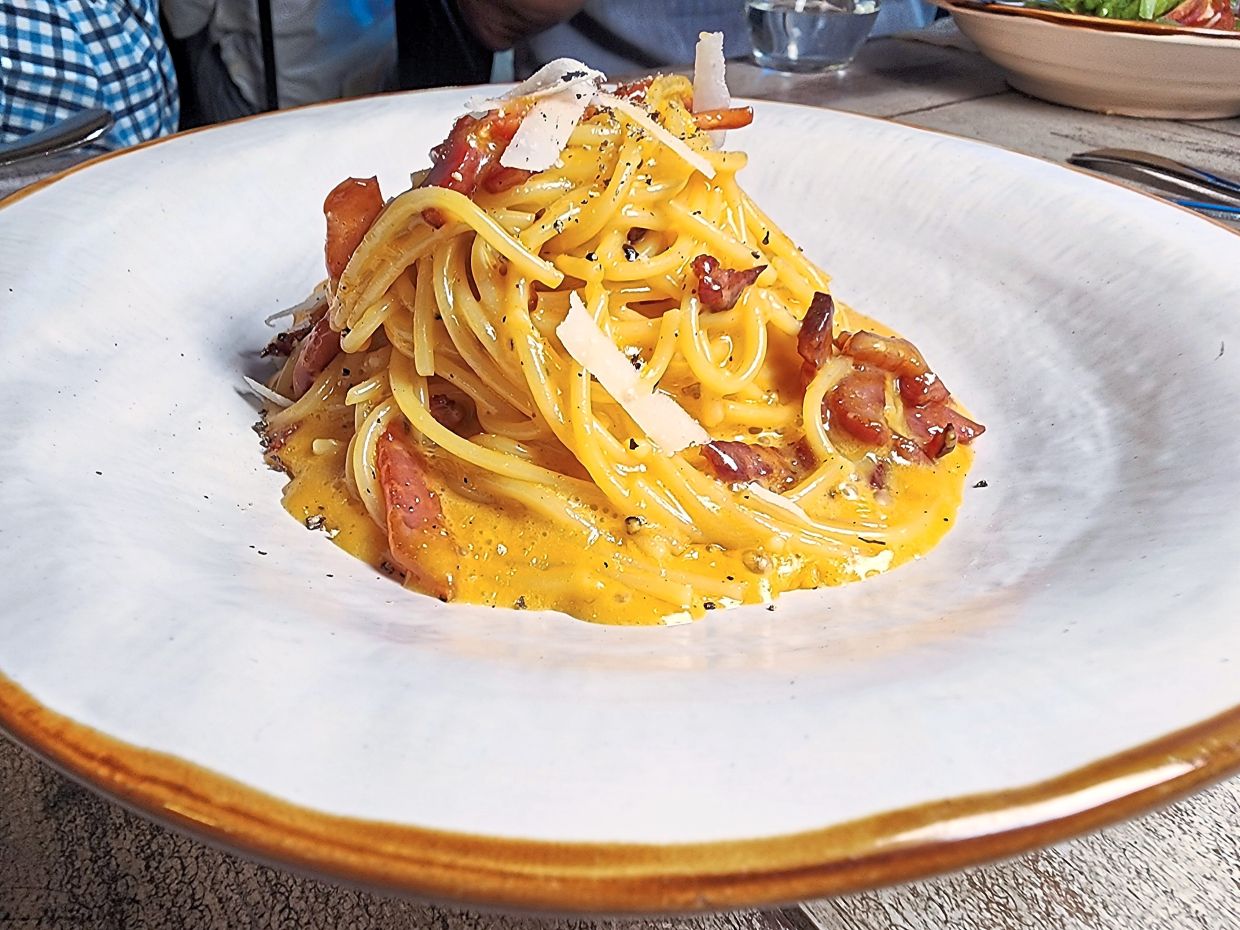 The carbonara is made the traditional way using eggs and Pecorino Romano instead of heavy cream. — ABIRAMI DURAI/The Star