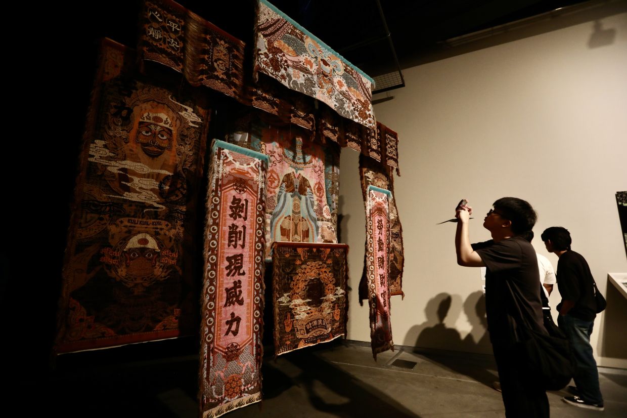 A view of Marcos Kueh's 'Divine Favor Holdings Berhad' (industrial weaving, 2025) artwork series at the 'Ilham Art Show 2025'. Photo: The Star/Low Lay Phon 