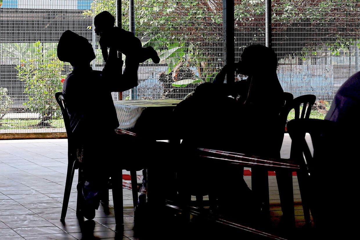Inmates meeting with their spouses and children during a Hari Raya Aidilfitri celebration at a PRP. — Photos: Bernama