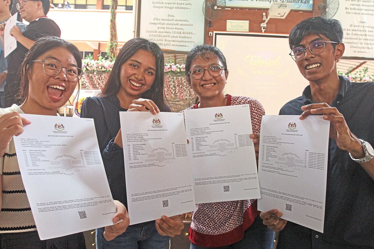 From left: Top students Khor Xin Yu, Nievedhaa, DC Savitta and Sanjay showing their SPM result certificates. — Photos: LIM BENG TATT/The Star