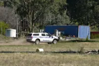 Police arrest two in investigation into Australian fugitive