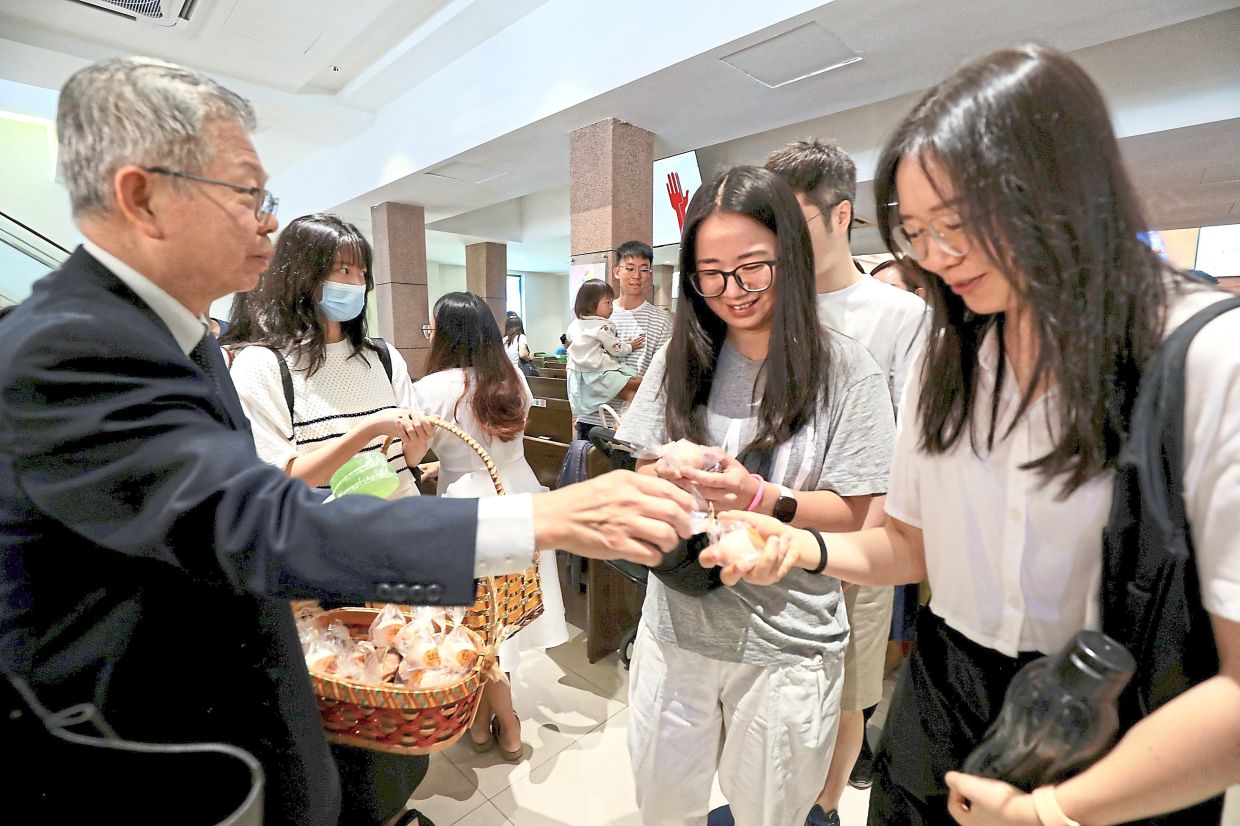 Kuala Lumpur Chinese Methodist Church worshippers receiving Easter eggs after the end of services. — LEONG WAI YEE/The Star 