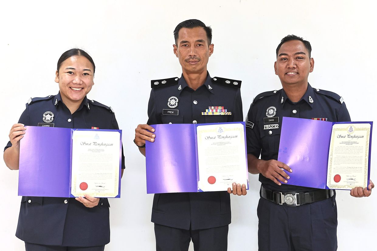 (From left) Konst Juanna, Insp Prem and Kpl Mohamad Zahid showing their letters of appreciation received in conjunction with the Police Day celebration. — THOMAS YONG/The Star