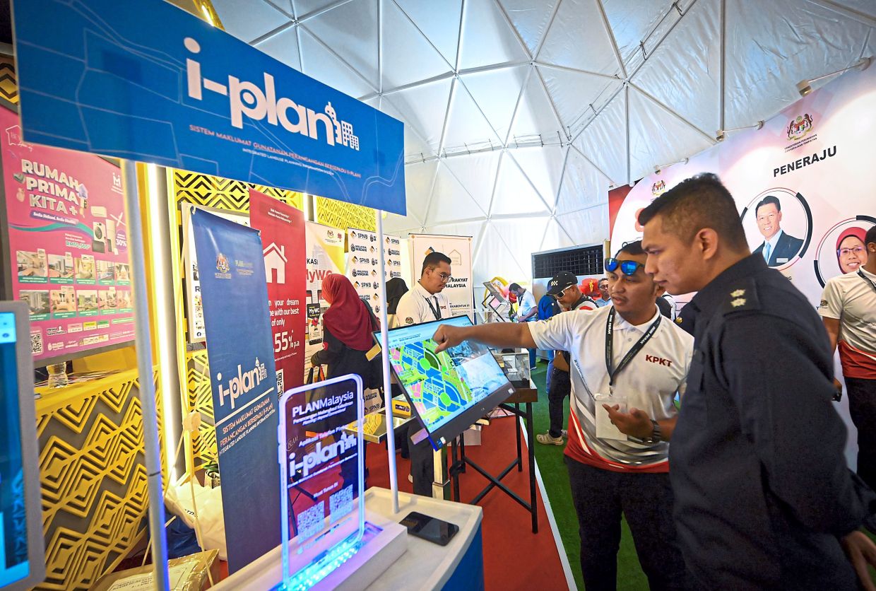 Visitors learning about i-Plan at the KPKT booth during PMR 2026, which took place on April 3-5. — RONNIE CHIN/The Star 