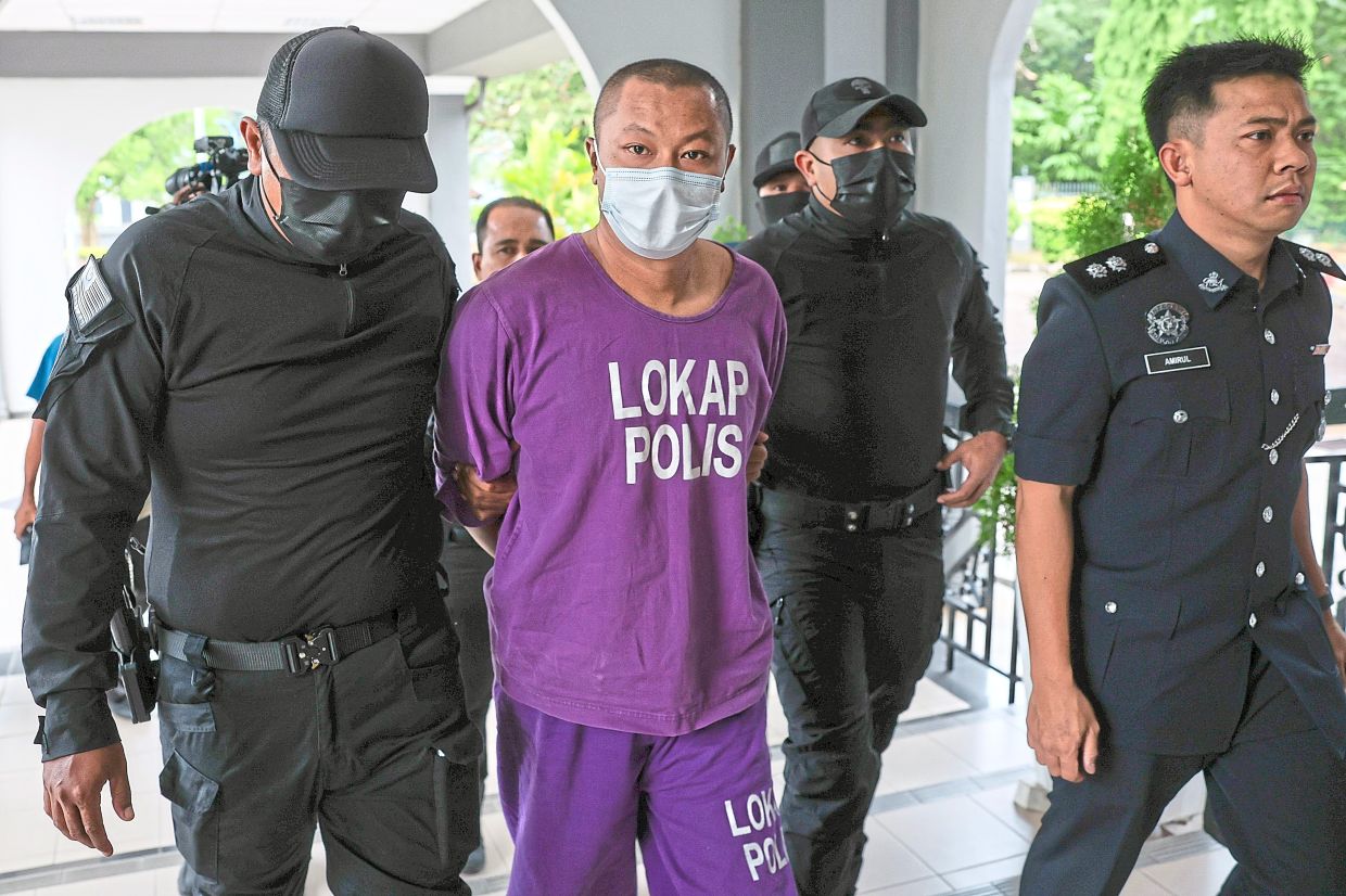 Charged with assault: Police escorting Sukry into the Bentong Magistrate’s Court. — Bernama