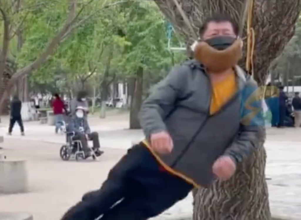 Extreme exercise: an elderly man suspends himself from a tree in a park in China. -- Photo: Weibo/SCMP