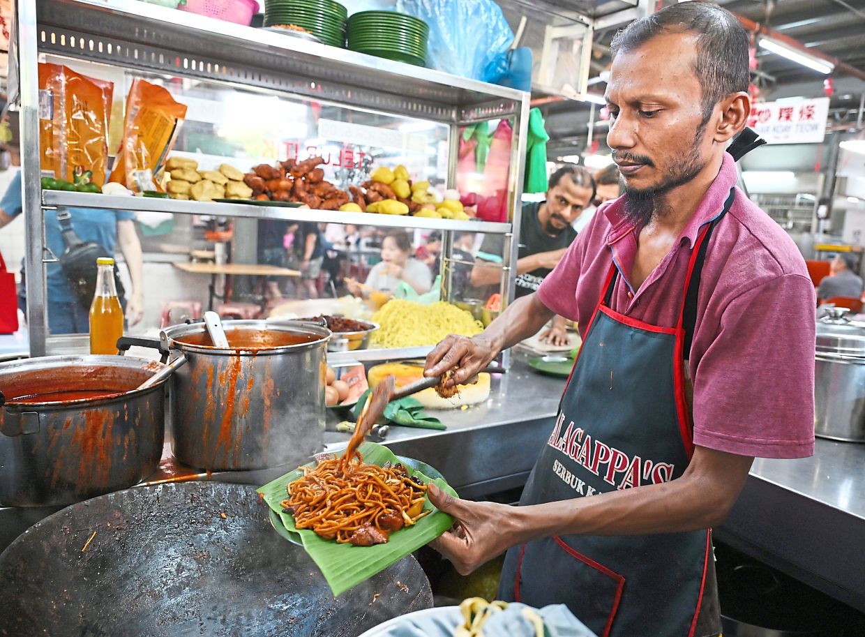 Muhammad Khalil says roughly 40% of market shoppers eventually stop by the food complex at Batu Lanchang market to dine or take away food.