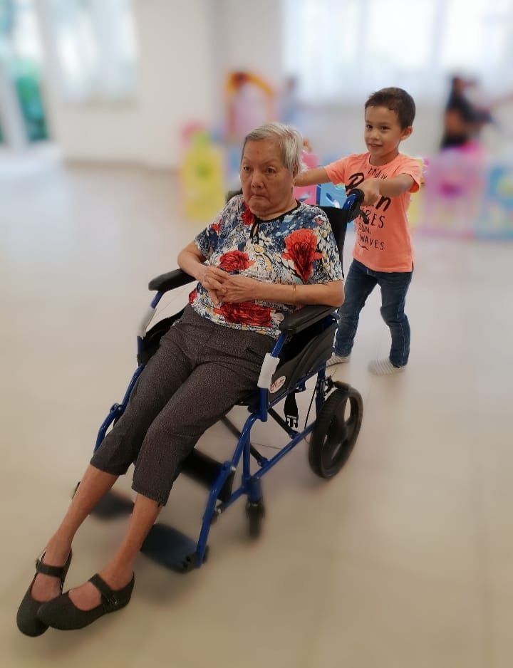 Children learn by observation, and the home is where it all begins, the writer reflects. Pictured is her youngest grandson with her mother, in a photograph taken several years ago. — LILY FU