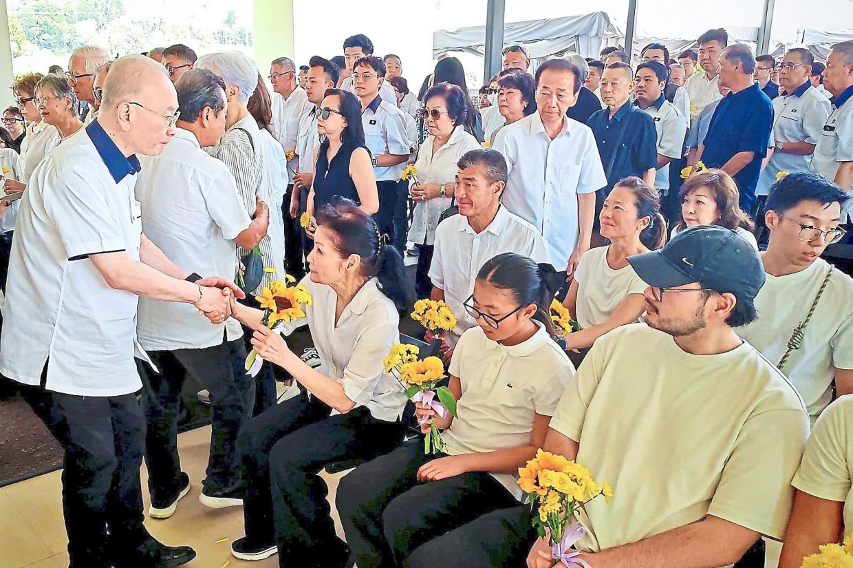 Dearly missed: Dr Wee cpmforting Dr Ling's wife at the funeral. — Photo courtesy of Dr Wee's Facebook page