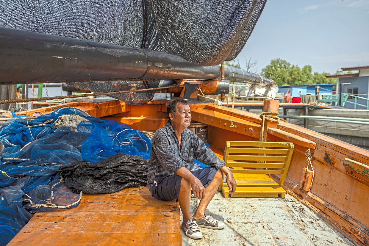 Wittaya Lekdee, a veteran fisherman who has not been able to take out his shrimp boat because of high fuel prices, at dock in the gulf city of Samut Sakhon, Thailand. — Lauren DeCicca/The New York Times