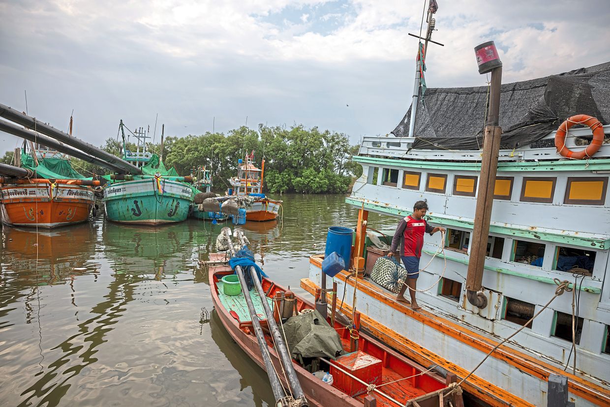 Fishermen perform maintenance on the shrimp boat “Lucky Blessing” while docked because of high diesel fuel prices and shortages, in Samut Sakhon, Thailand, March 16, 2026. Across Southeast Asia, a region heavily dependent on energy exports that move through the Strait of Hormuz, lives are being upended by rising oil and gas prices due to the U.S. and Israel’s war on Iran and the country’s responding attacks in the waterway. (Lauren DeCicca/The New York Times)