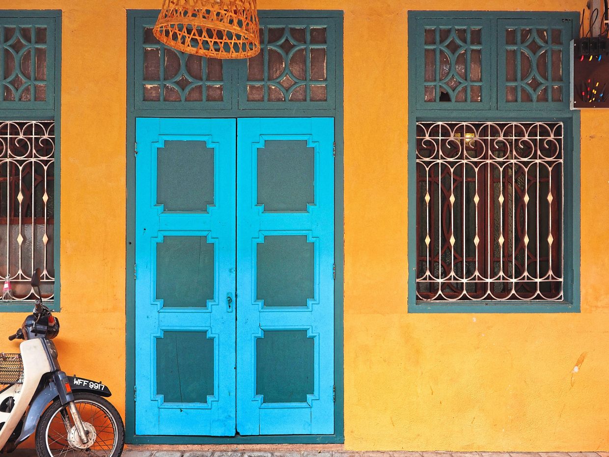 A view of the original door and window with ornate metal grilles located on one side of the Terrace. Photo: Ken Choong