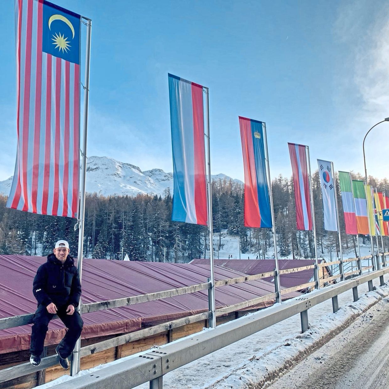 Yaw - the first South-East Asian athlete to qualify at the 2023 Bobsled and Skeleton World Championships - poses with the Malaysian flag. Photo: Jonathan Yaw