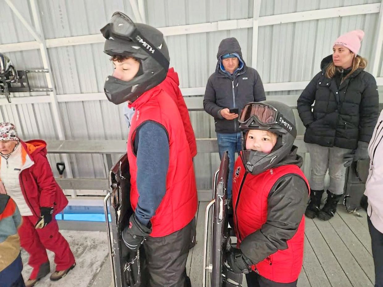 Alexis (right), the little girl Yaw gave his medal to, and her 15-year-old brother John (left), who was inspired by Yaw and took up skeleton sport competitively, targeting the Youth Winter Olympics. Photo: Jonathan Yaw
