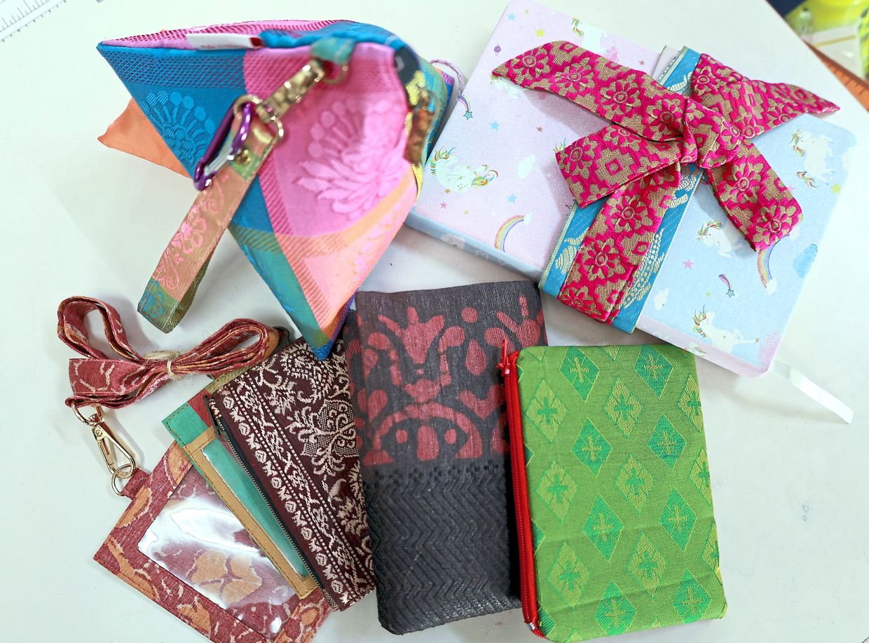 Saree fabrics repurposed into pouches, purses, and lanyards.