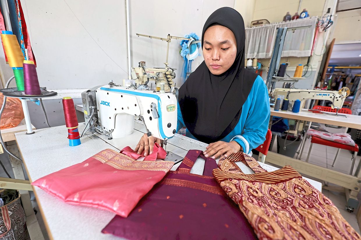 With flexible work hours at SAV, Shakira Syafiqa, 20, has the opportunity to improve her earnings while building her sewing skills.