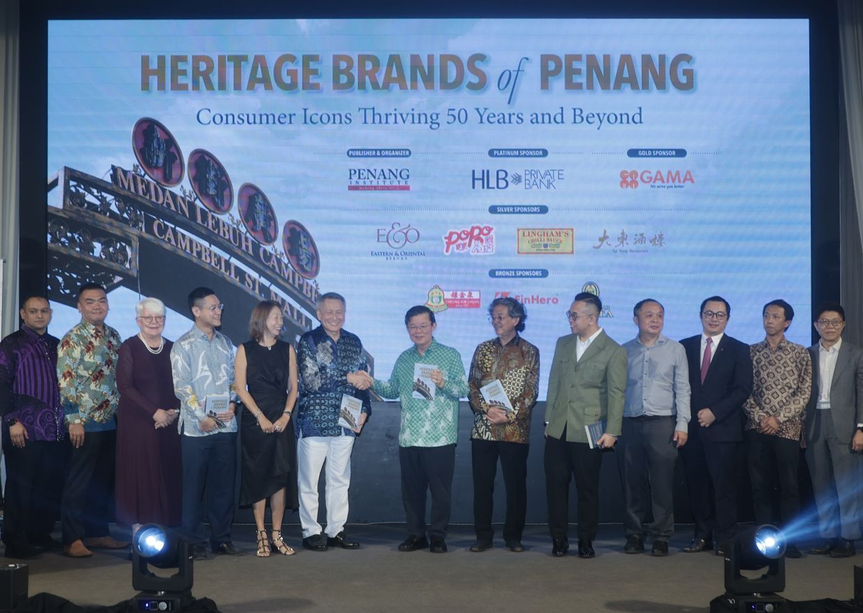 (From 6th left)Author Datuk Tony Yeoh, Penang Chief Minister Chow Kon Yeow, Penang Institute executive director Datuk Dr Ooi Kee Beng and Entrepreneur and Cooperatives Development Minister Steven Sim pictured during the launch of the 'Heritage Brands of Penang' book. With them are State Infrastructure, Transport and Digital committee chairman Zairil Khir Johari (4th) and representatives from sponsors.— ZHAFARAN NASIB/The Star