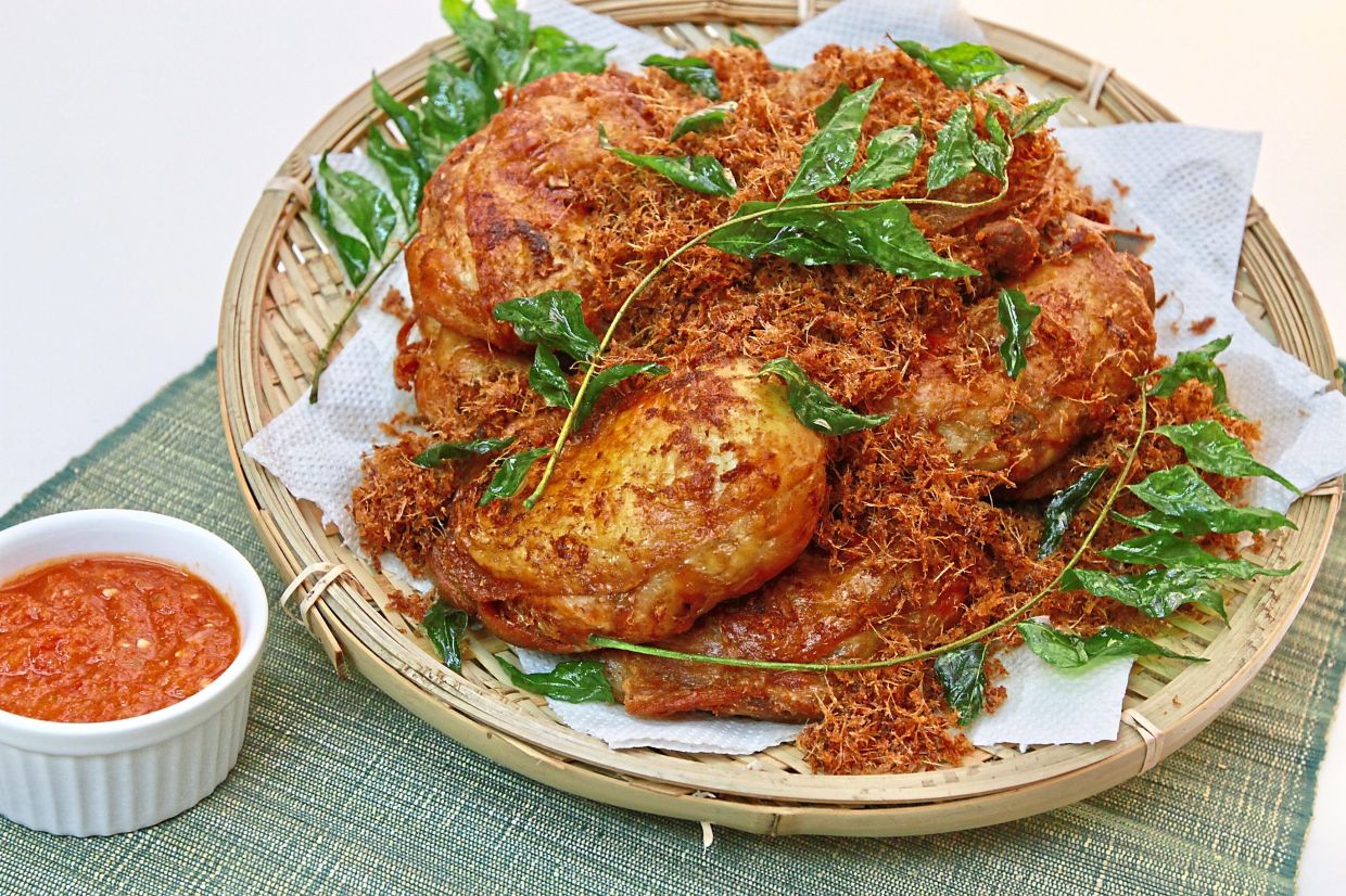 Ayam goreng berempah is hugely popular in Malaysia, where it is eaten as is or served alongside other dishes like nasi lemak. — Filepic 