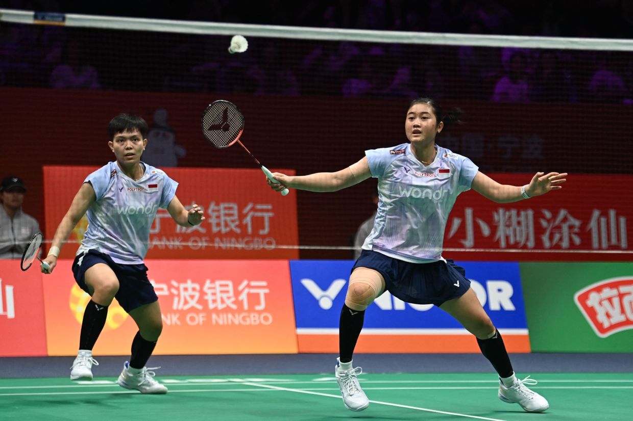 Amallia Cahaya Pratiwi (right) and Siti Fadia Silva Ramadhanti of Indonesia hit a return to Rin Iwanaga and Kie Nakanishi of Japan during their women's doubles quarter-final match at the Badminton Asia Championship in Ningbo, eastern China's Zhejiang province on Friday, April 10, 2026. -- Photo by CN-STR / AFP