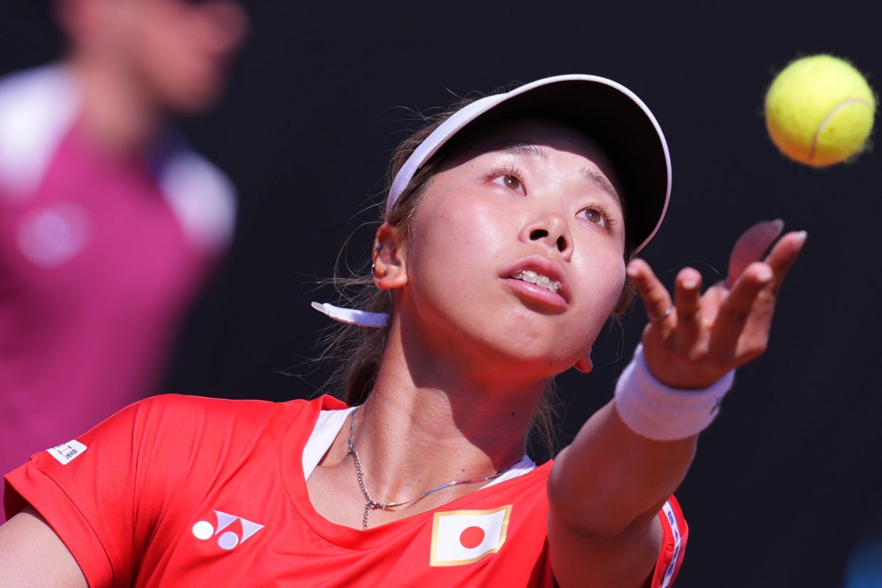Japan's Himeno Sakatsume serves to Italy's Jasmine Paolini during the Billy Jean King Cup match between Italy and Japan in Velletri, Italy, on Friday, April 10, 2026. -- Alfredo Falcone/LaPresse via AP
