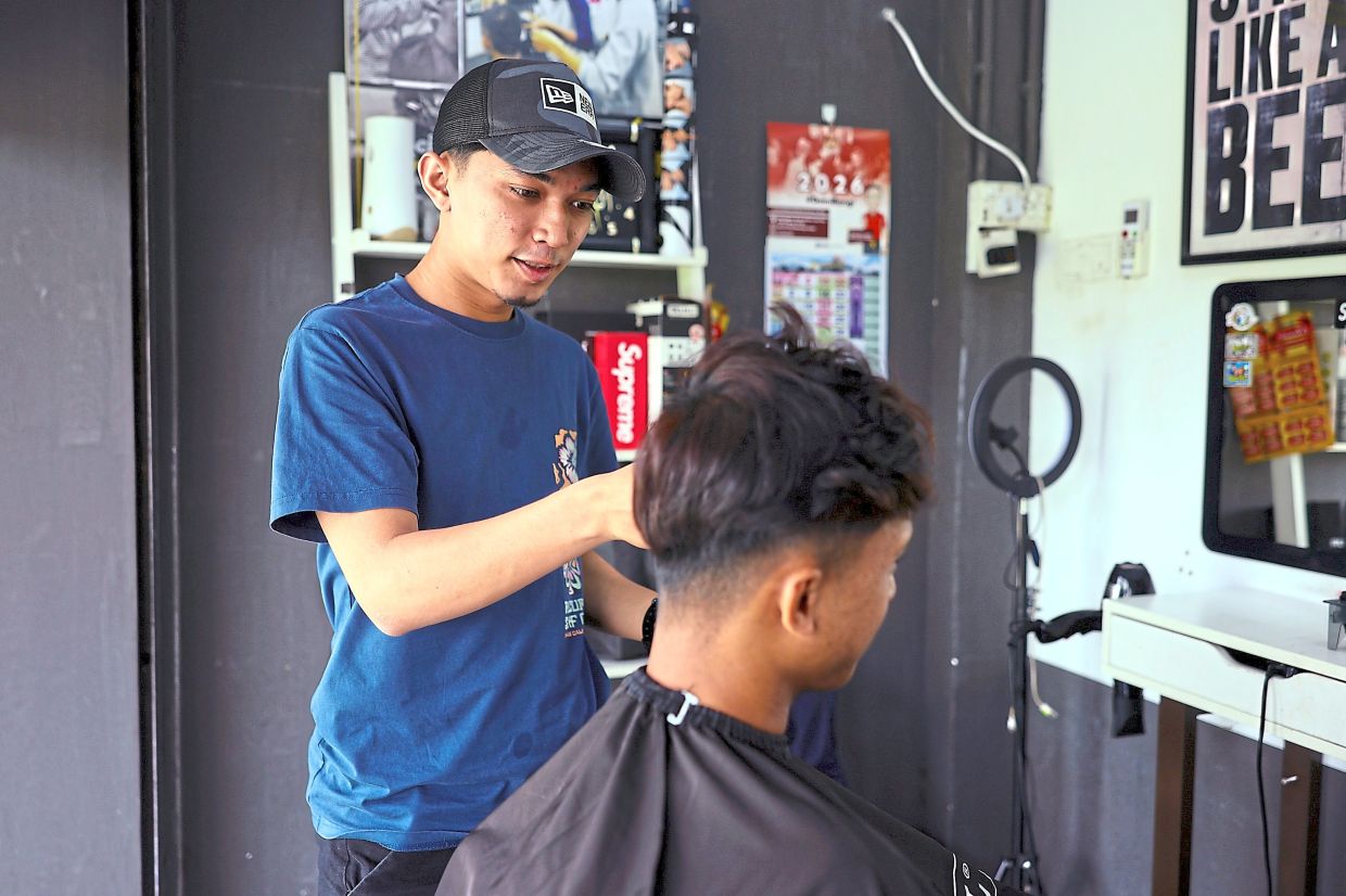 Muhammad Ammar at the AYG Barbershop in Bandar Baru Bangi.
