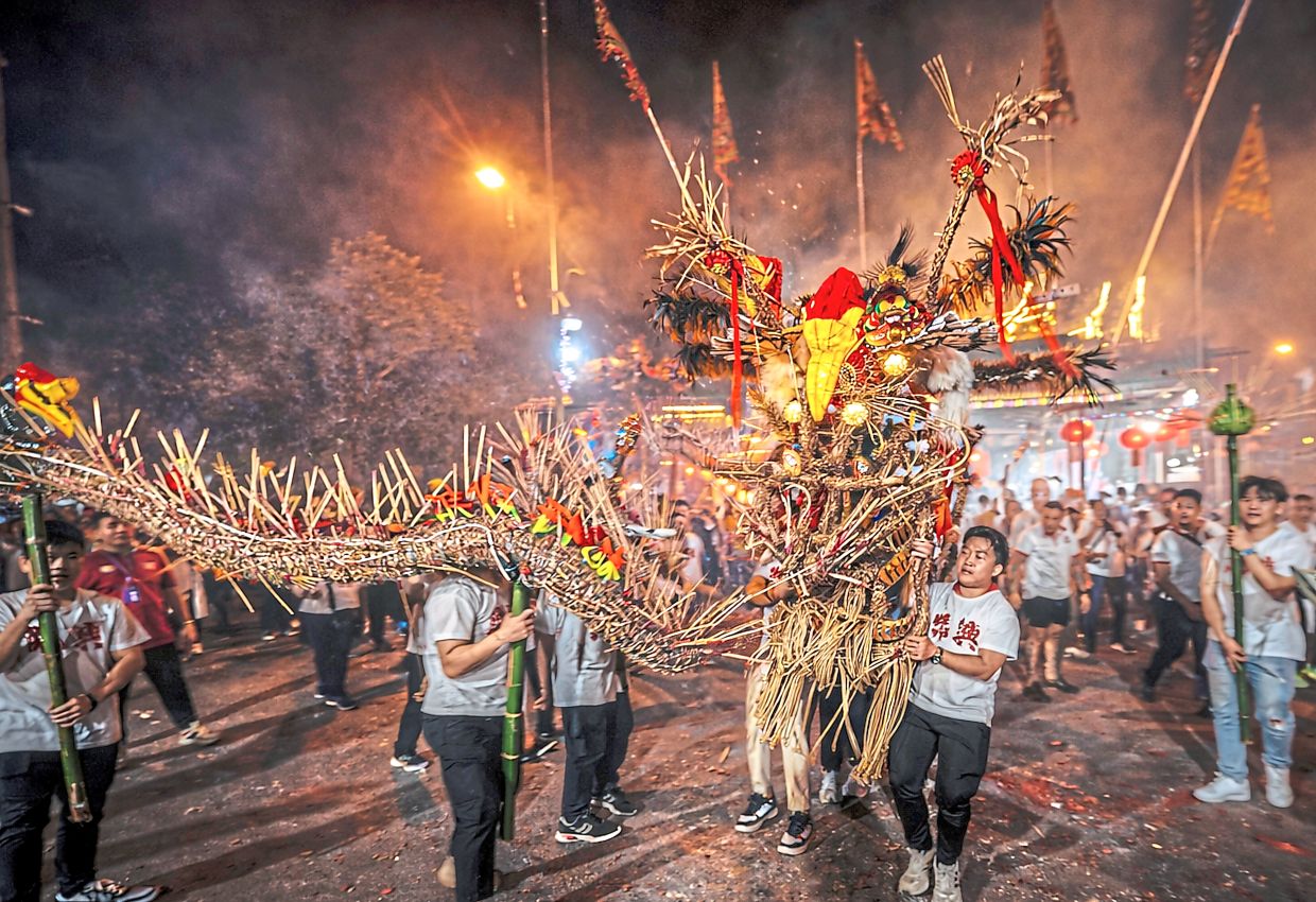 The 90m-long dragon was locally crafted by the Lien Heng Wushu Association, one of 222 troupes taking part in the annual procession on Thursday evening.