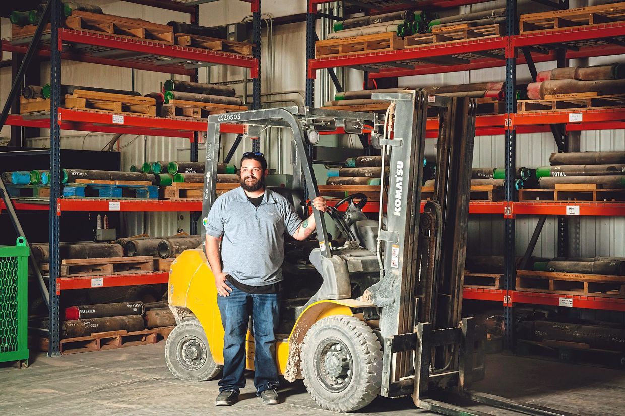 Stacey posing for a photo at Defender Tubular Services in Odessa, Texas. — Desiree Rios/The New York Times