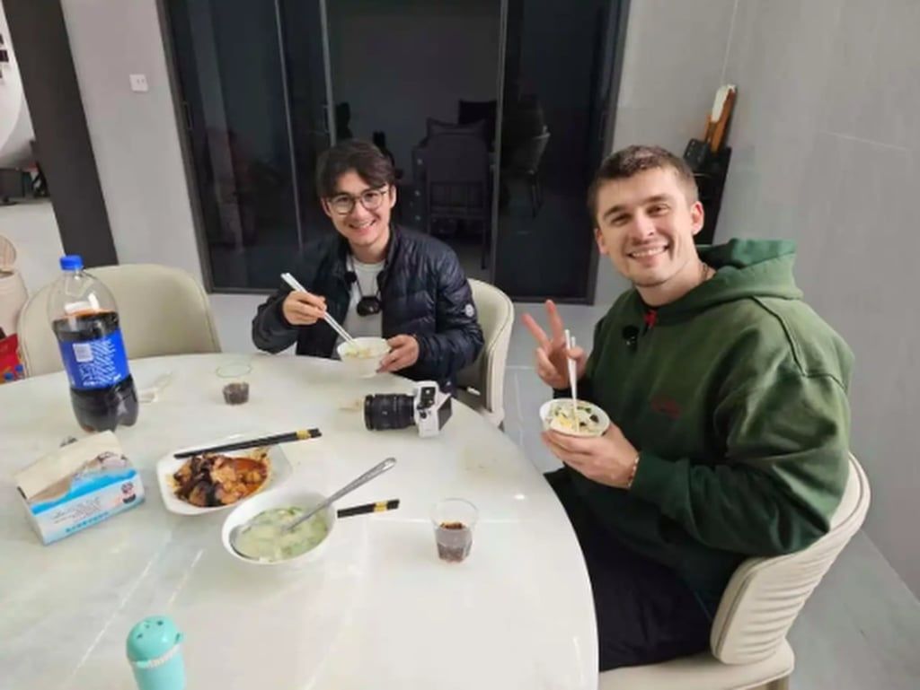 The two American tourists, above, tuck into the meal that was prepared for them. - Photo: Baidu