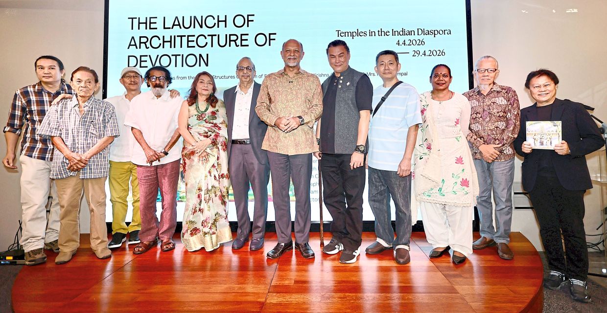 (From fifth left) Kamla, Prof Krishna, Gobind, and Adrianta alongside Tan (right) and some of the artists at the exhibition in Kuala Lumpur.