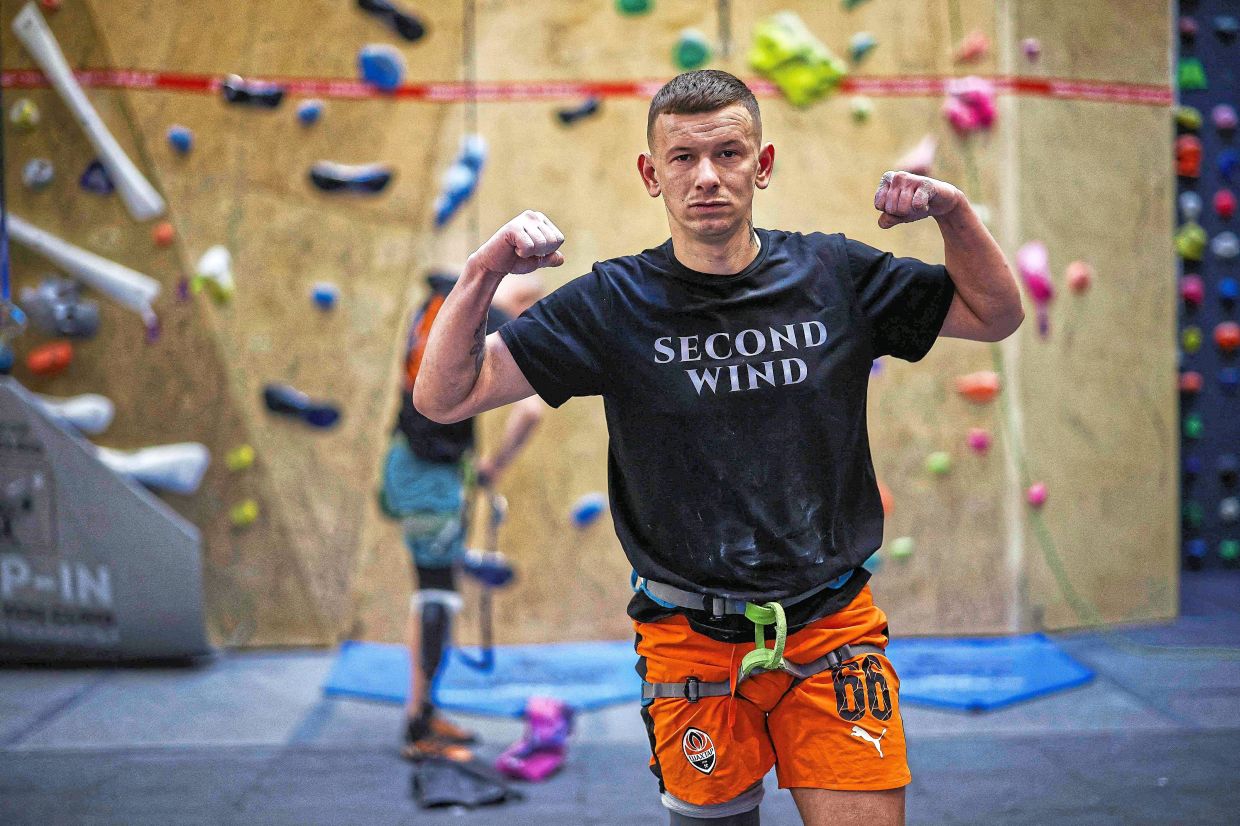 Former Ukrainian service member Dmytro Mekhasiuk, who was injured in the war against Russia and has a prosthetic right leg, during an indoor climbing session.